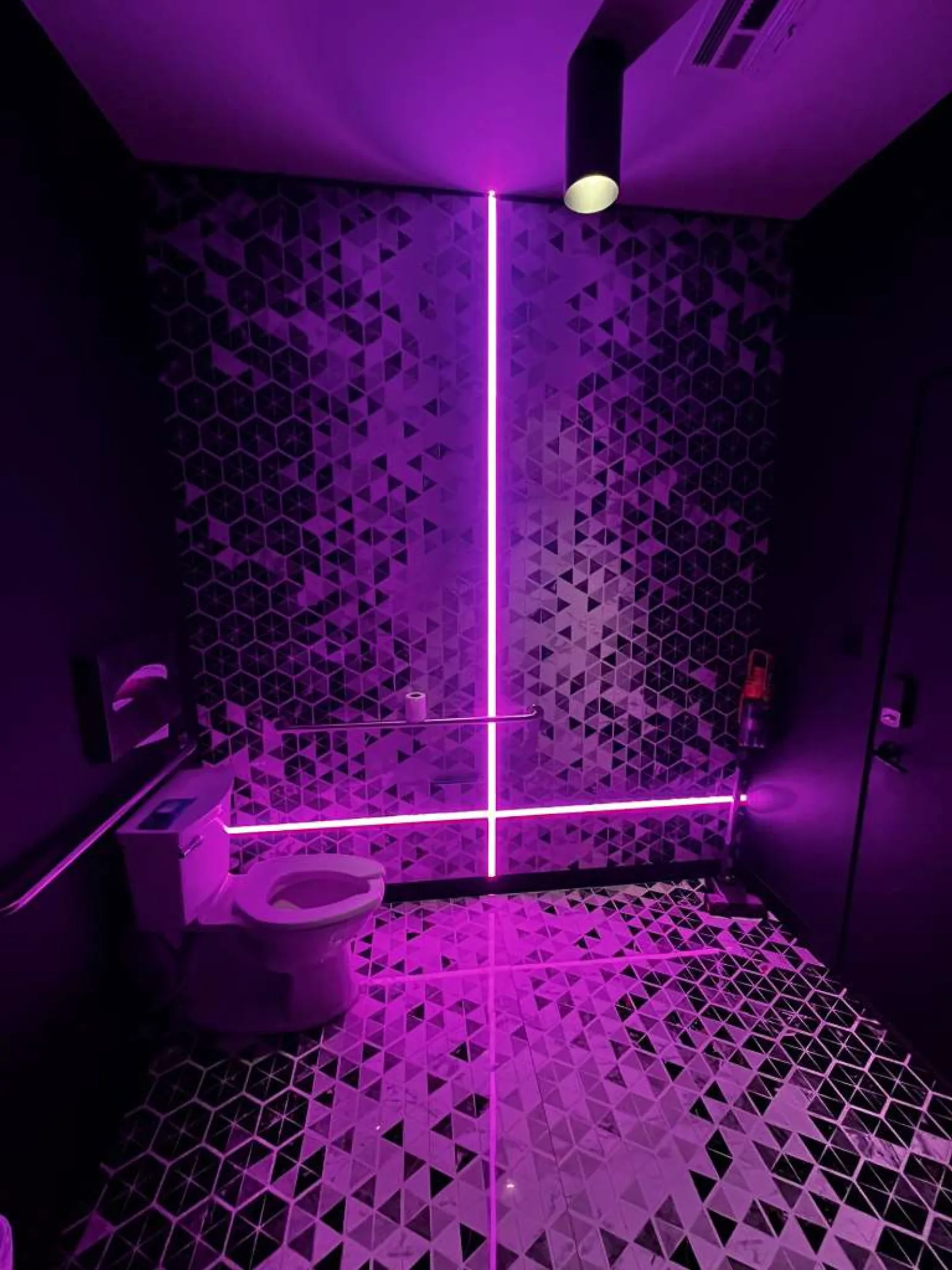 Bathroom with geometric tile and neon LED lighting