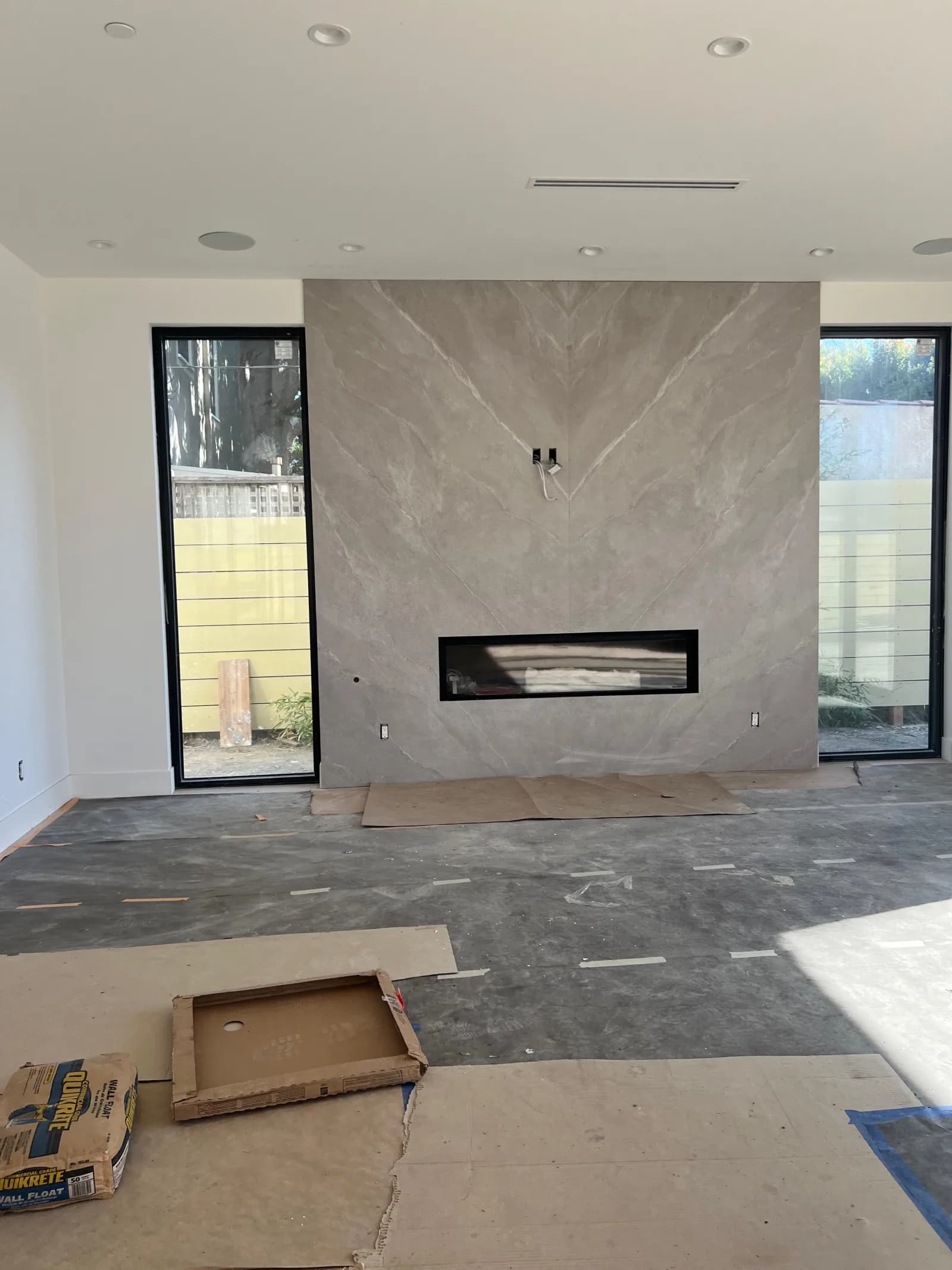 Living room with linear gas fireplace and stone slab surround